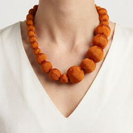 Collar Seda Lonh naranja sobre modelo con camiseta blanca