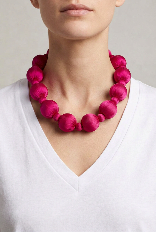 Collar Seda Linh rosa sobre modelo con camiseta blanca